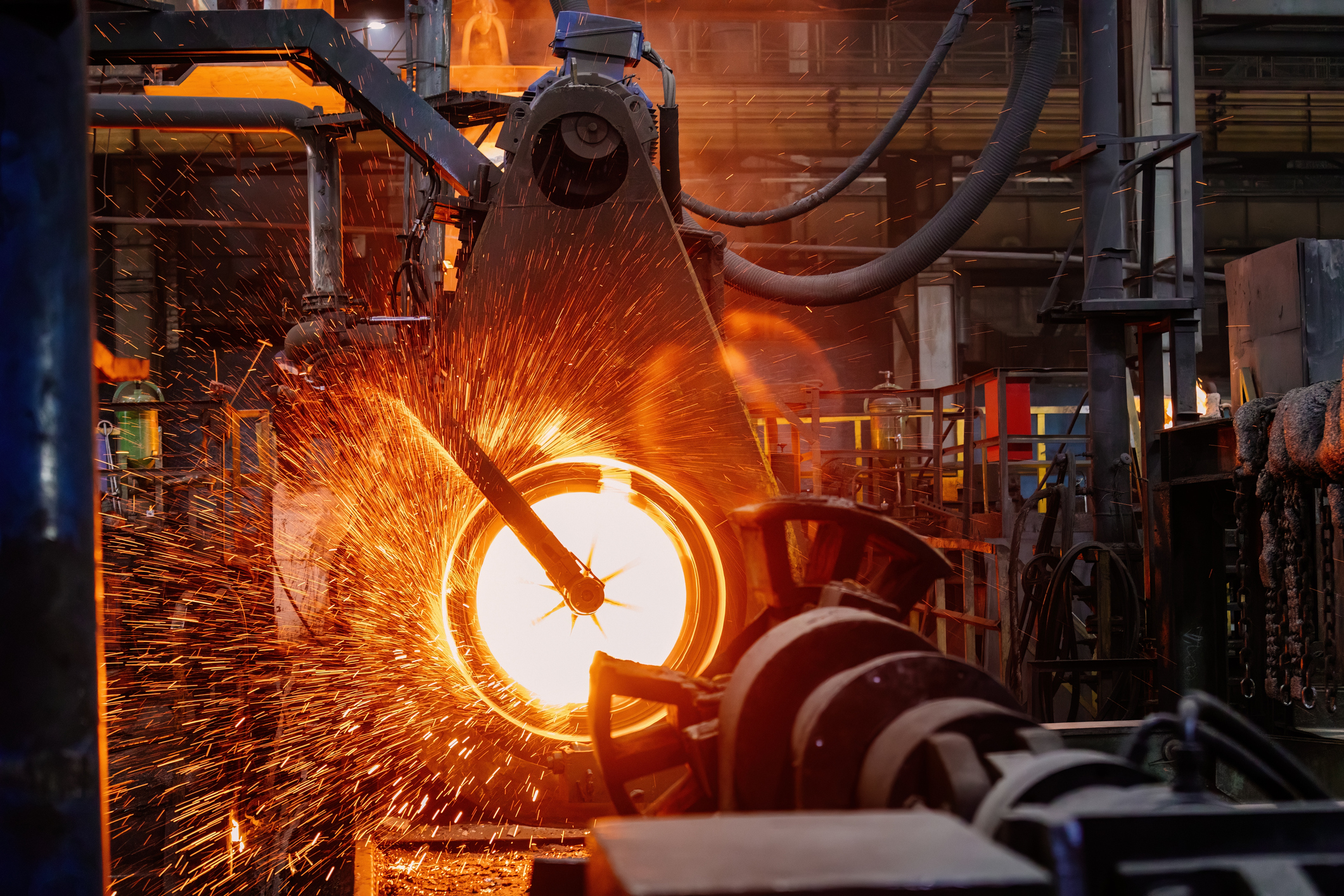 Hot steel pipe passing through a rolling mill